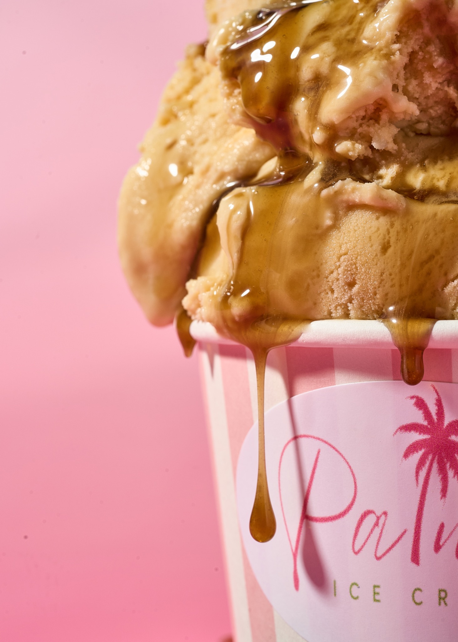 Palmas ice cream with caramel drizzling over a pink branded cup